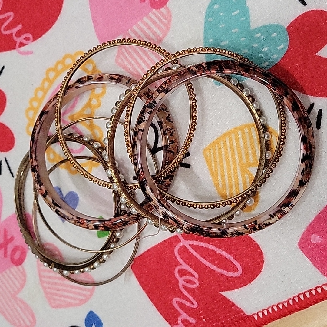 A Collection Of 9 Antiqued Bangles.